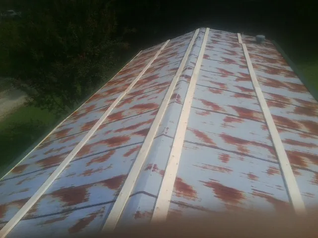 Rusted metal roof panels with new wood purlins before replacement — Storm Damage Roof Repair in Mascotte by Roofing Brothers