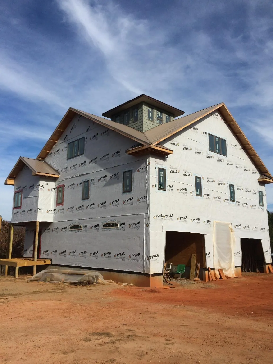 New two story house under construction with a cupola and gabled roofs in Mascotte
